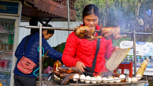 Lowlanders selling barbecue chicken at a stand in Hàm Rồng park.